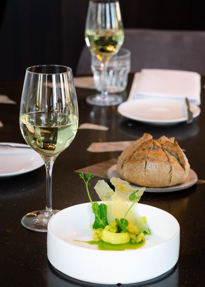 Food and wine on a marble table at IJssel Restaurant